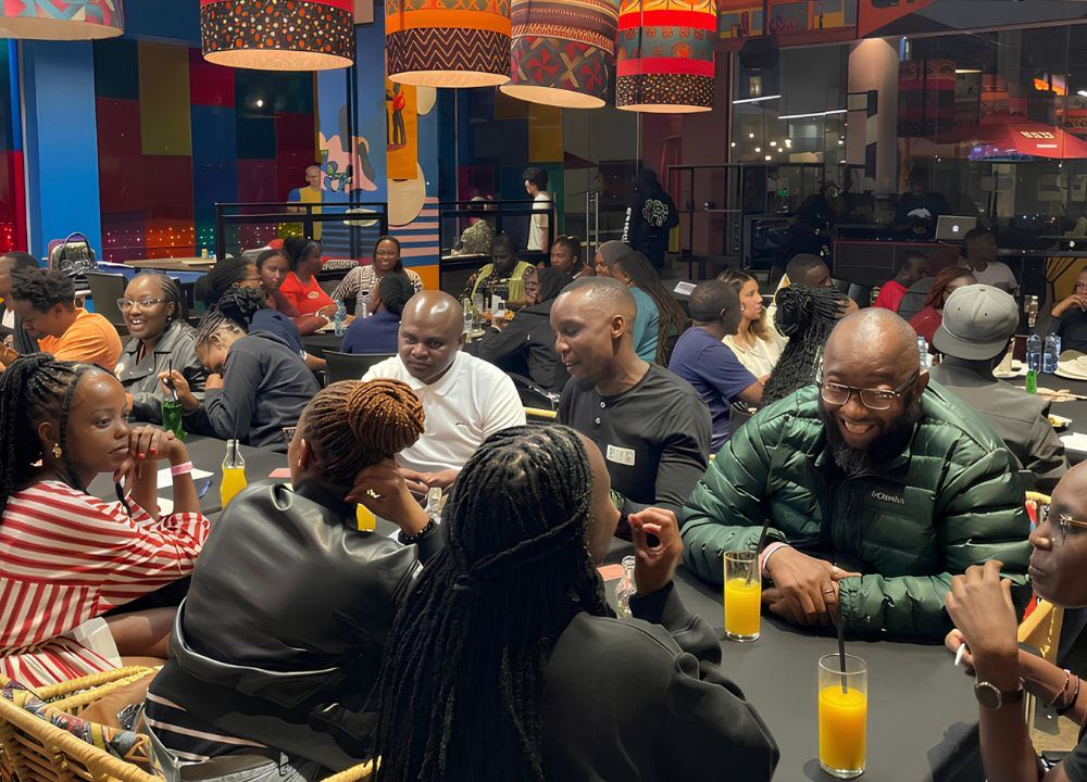 A full room of guests talking and drinking together at a Social Tribe community event